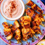 Paprika Chicken Skewers on a plate with paprika dip.