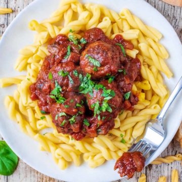 Slow Cooker Meatballs on a plate with a fork.