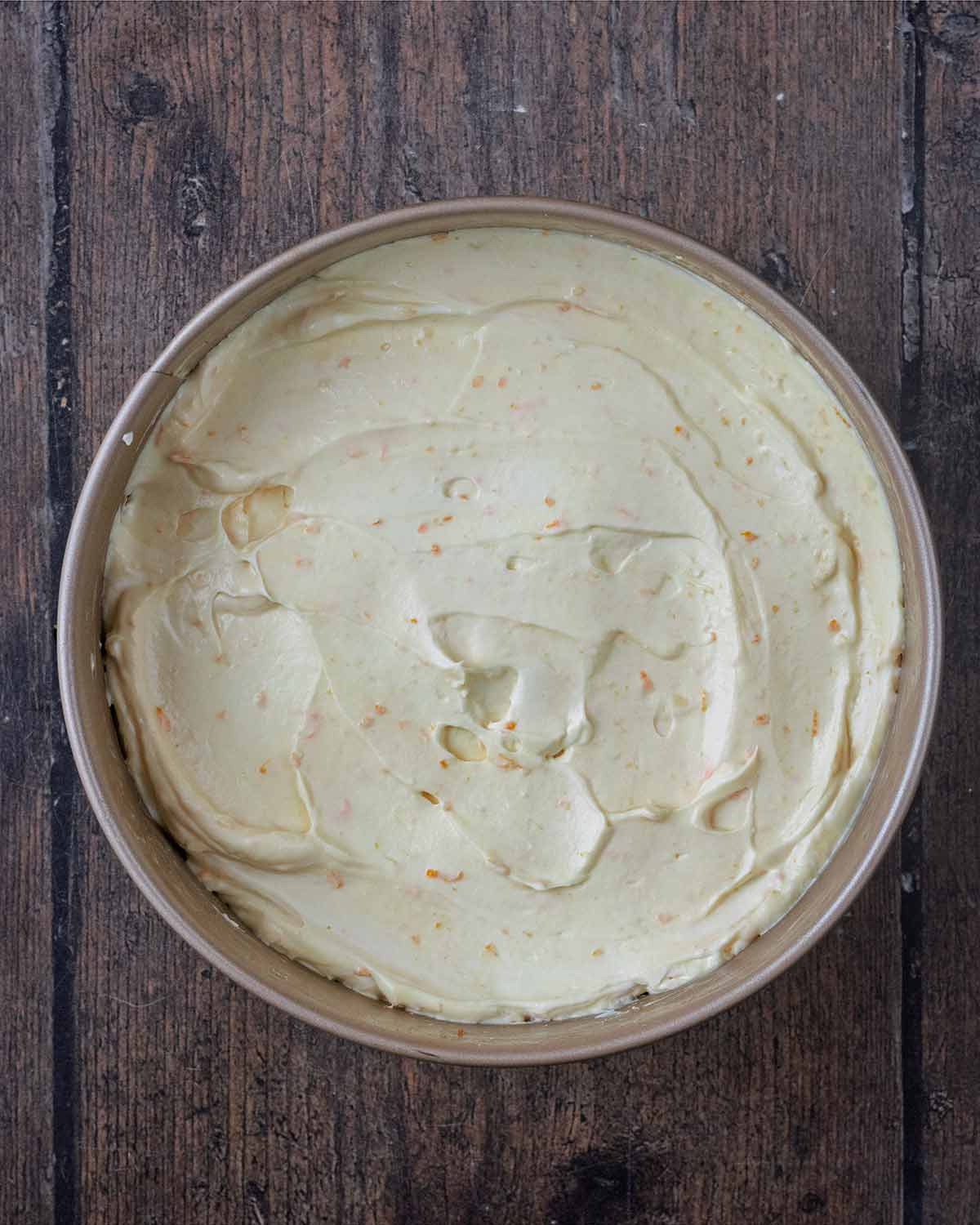 The cheesecake mixture on top of the chilled biscuit base.