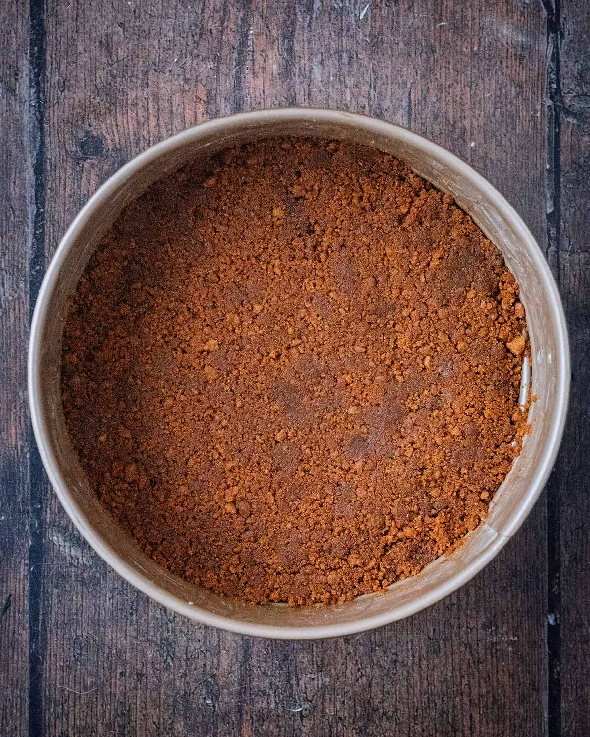 The butter and biscuit mixture packed down into the baking tin.