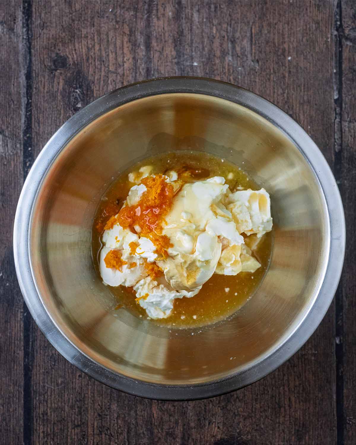 Cream cheese, vanilla, orange zest and orange juice in a mixing bowl.
