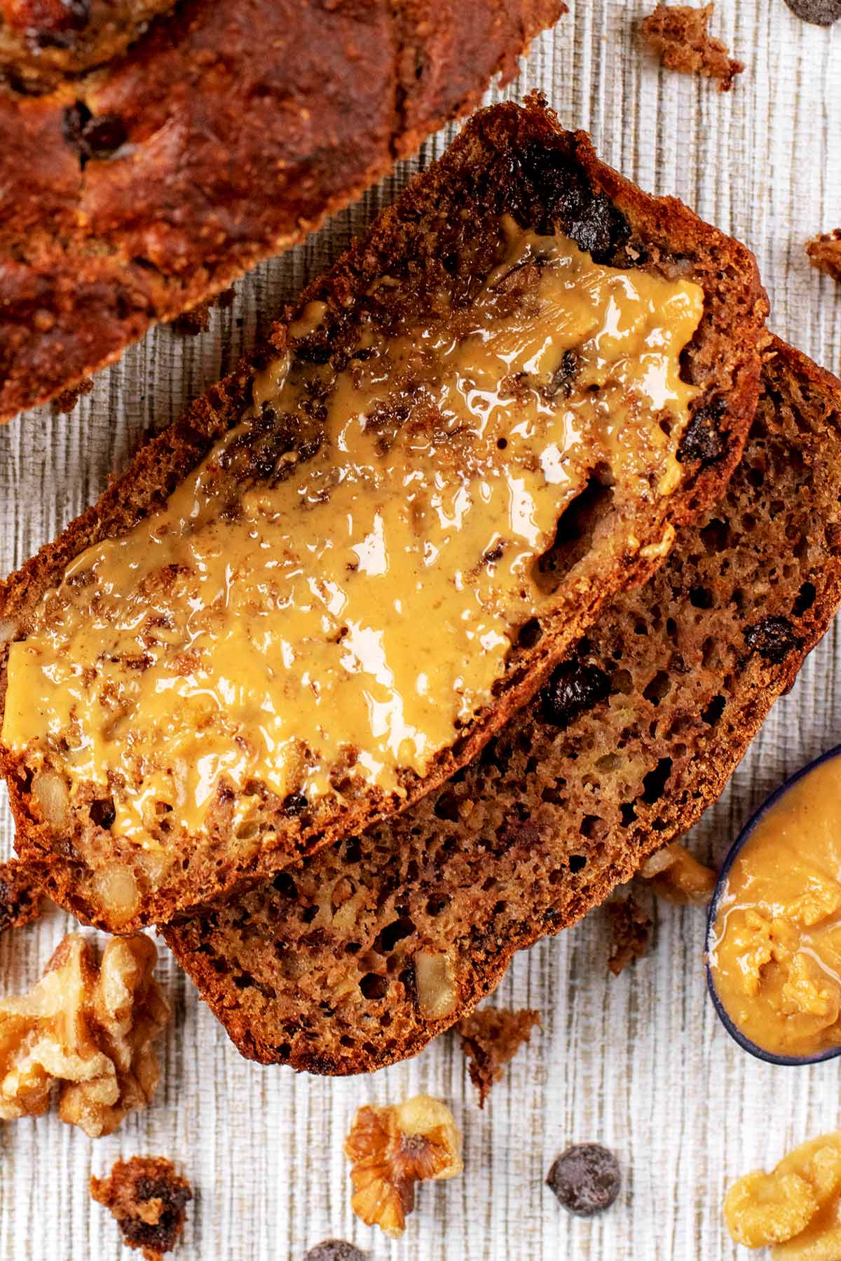 A slice of Banana Bread spread with peanut butter.