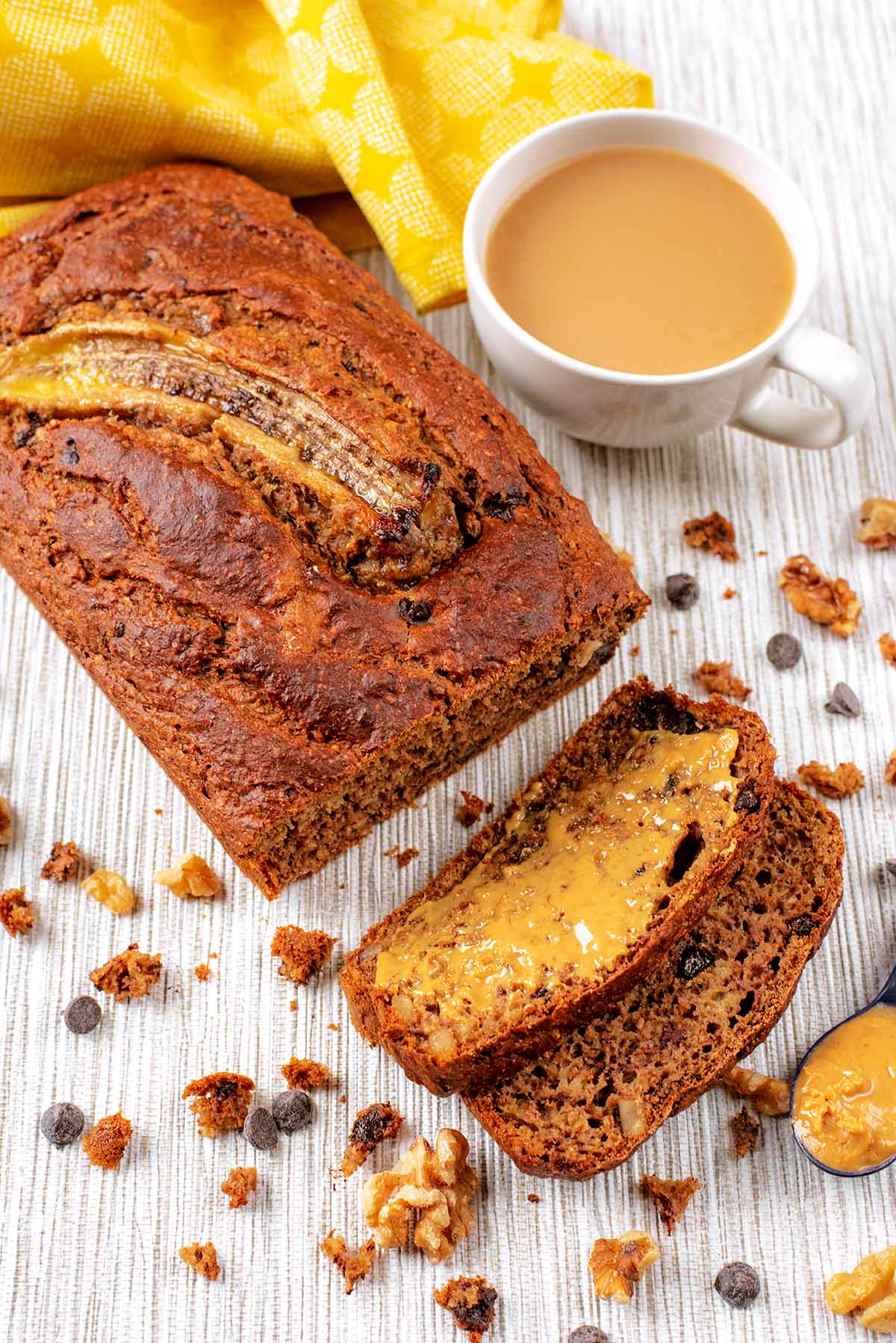 Banana bread next to a cup of tea.