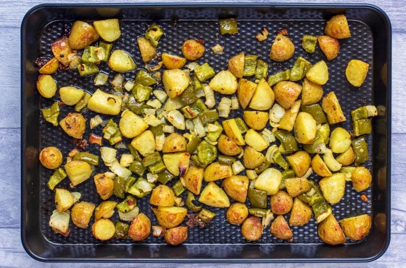 A baking tray covered in baked home fries.