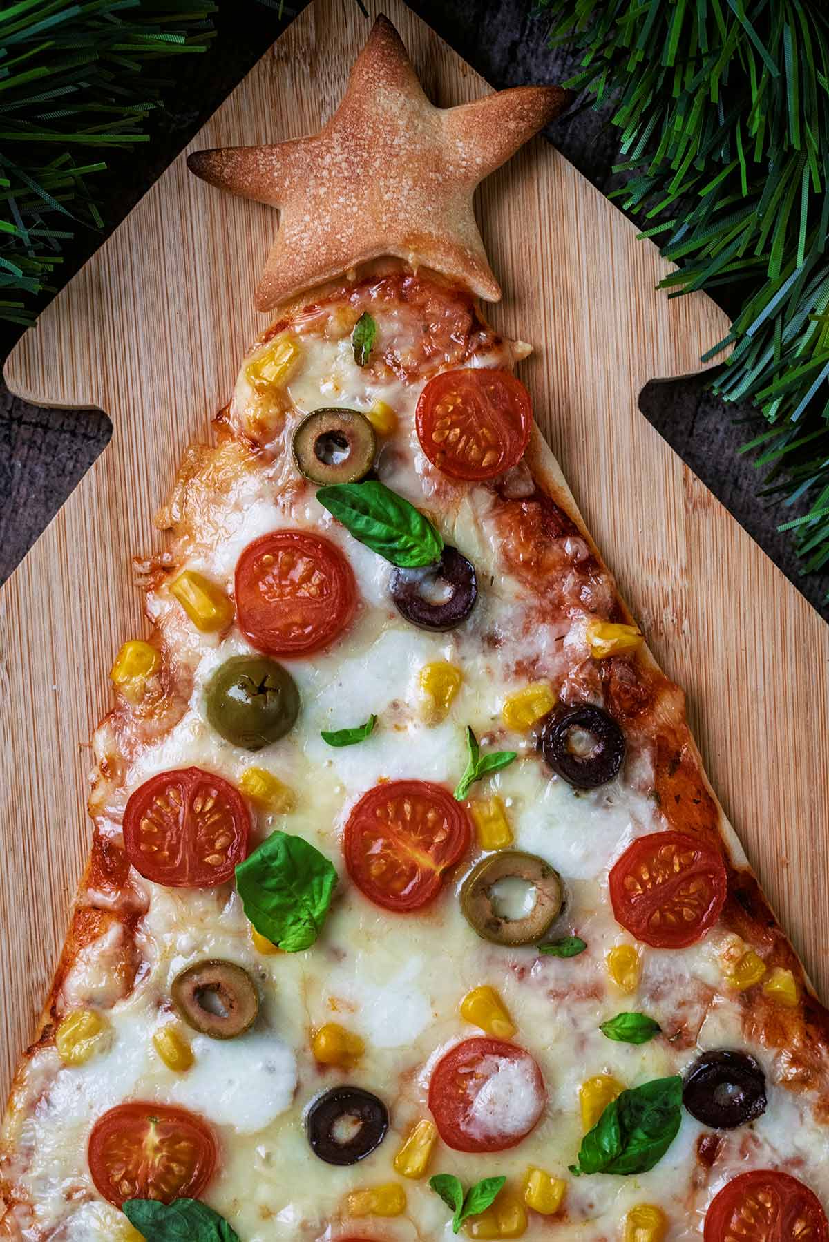 The top of a triangular pizza with a pizza dough star.