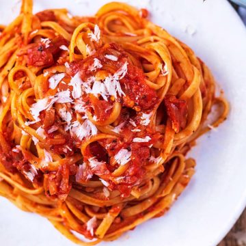 Easy tomato pasta sauce coating tagliatelle on a white plate.