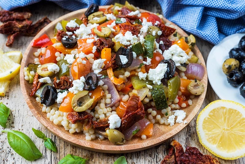 Couscous salad topped with olives and feta.