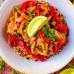 Slow Cooker Thai Chicken Curry in a white bowl, topped with a lime wedge.