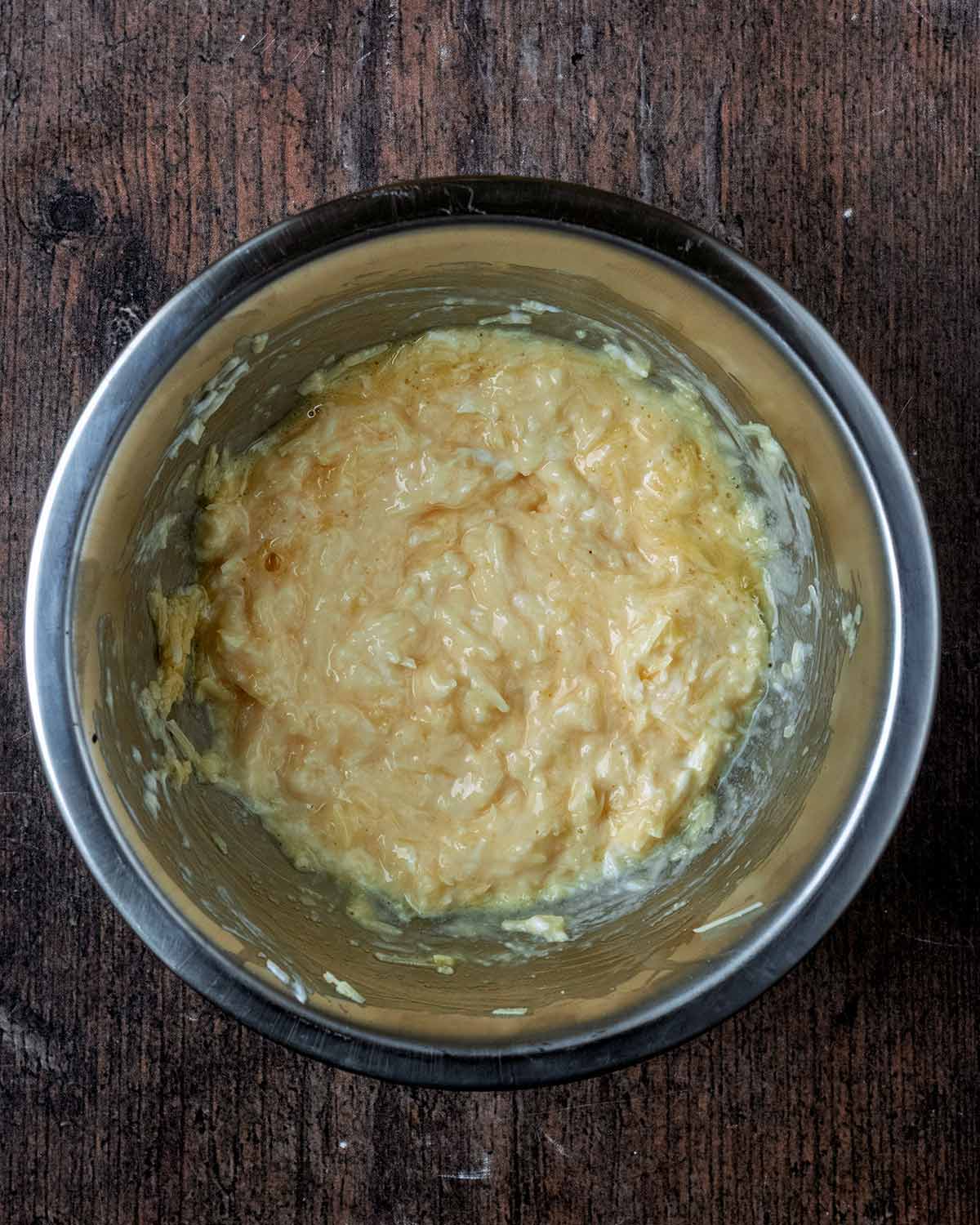 A mixture of egg, yogurt and cheese in a mixing bowl.