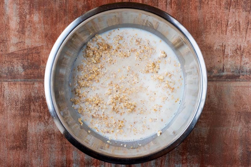 Oats and milk in a large mixing bowl.
