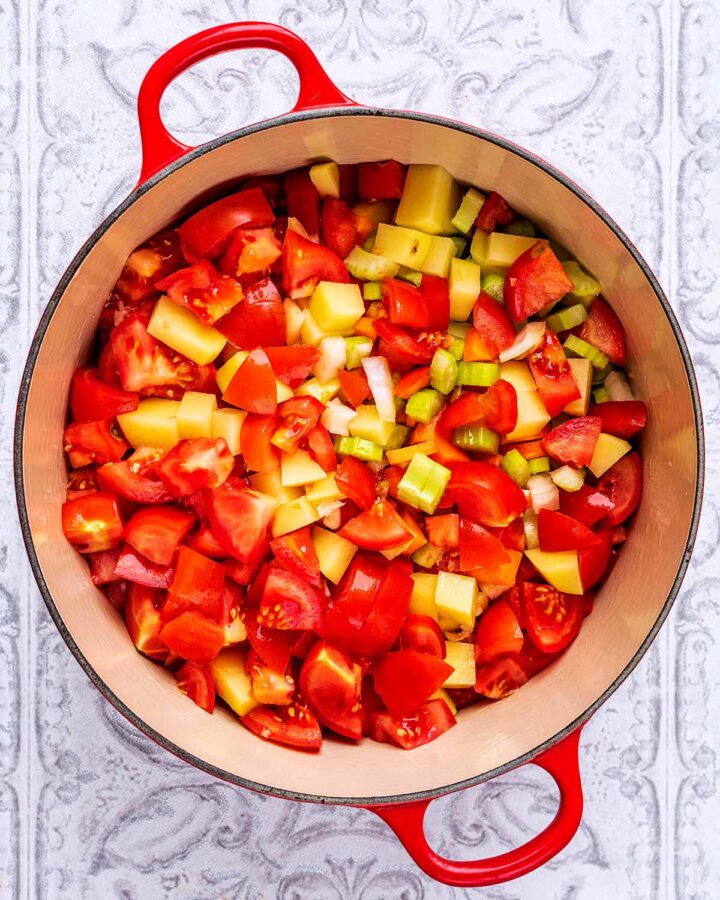 A large red pot containing chopped vegetables.
