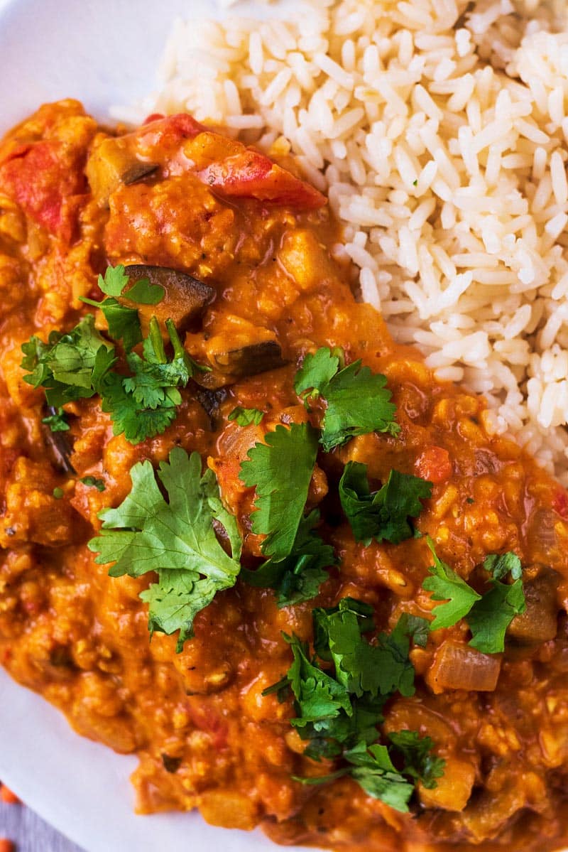 A lentil curry with chopped cilantro sprinkled on top of it.
