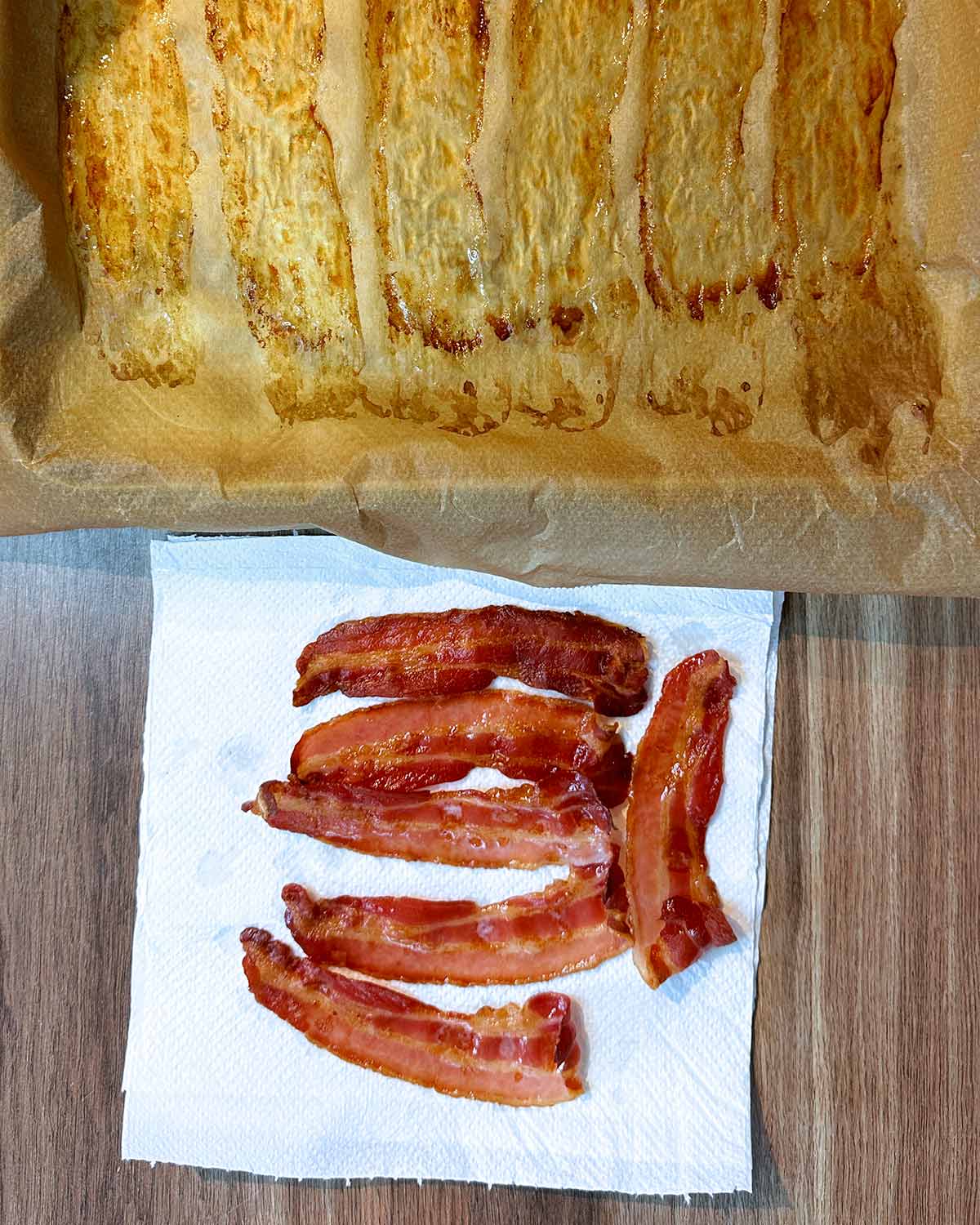 Cooked bacon rashers laying on a sheet of paper towel.