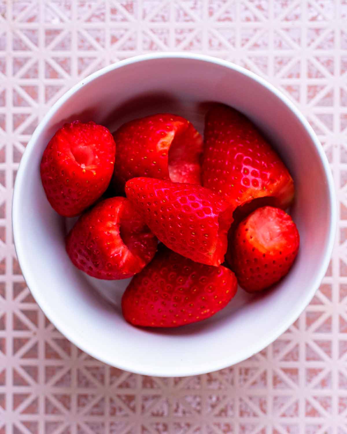 A small bowl of hulled strawberries.