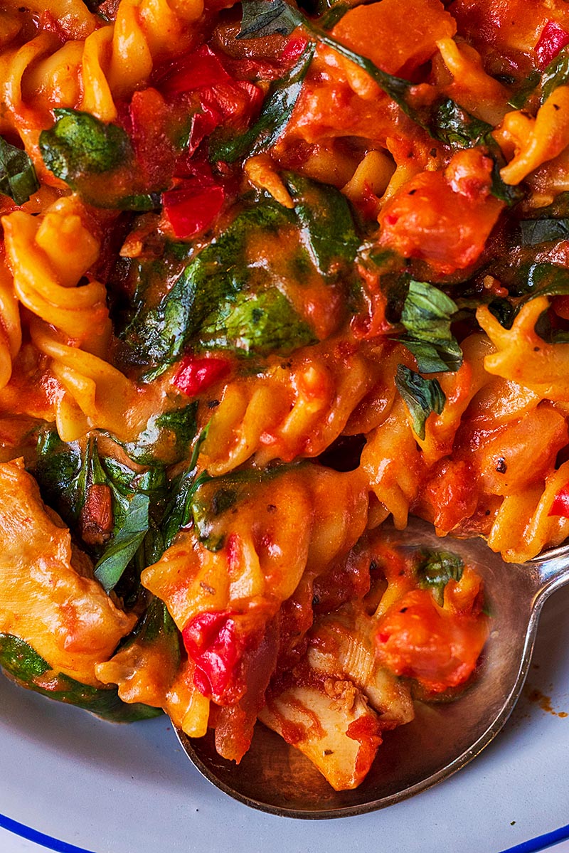 Fusilli pasta in a tomato sauce with spinach.