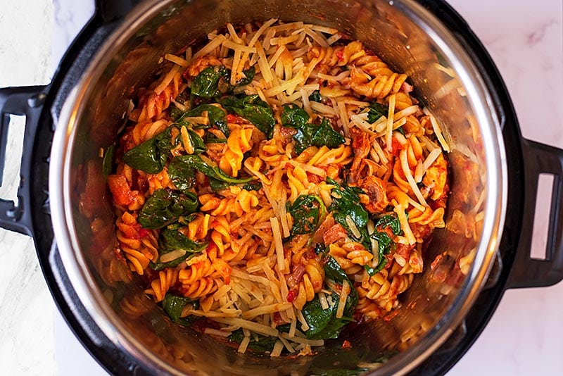 Tomato pasta with spinach and cheese in an instant pot.