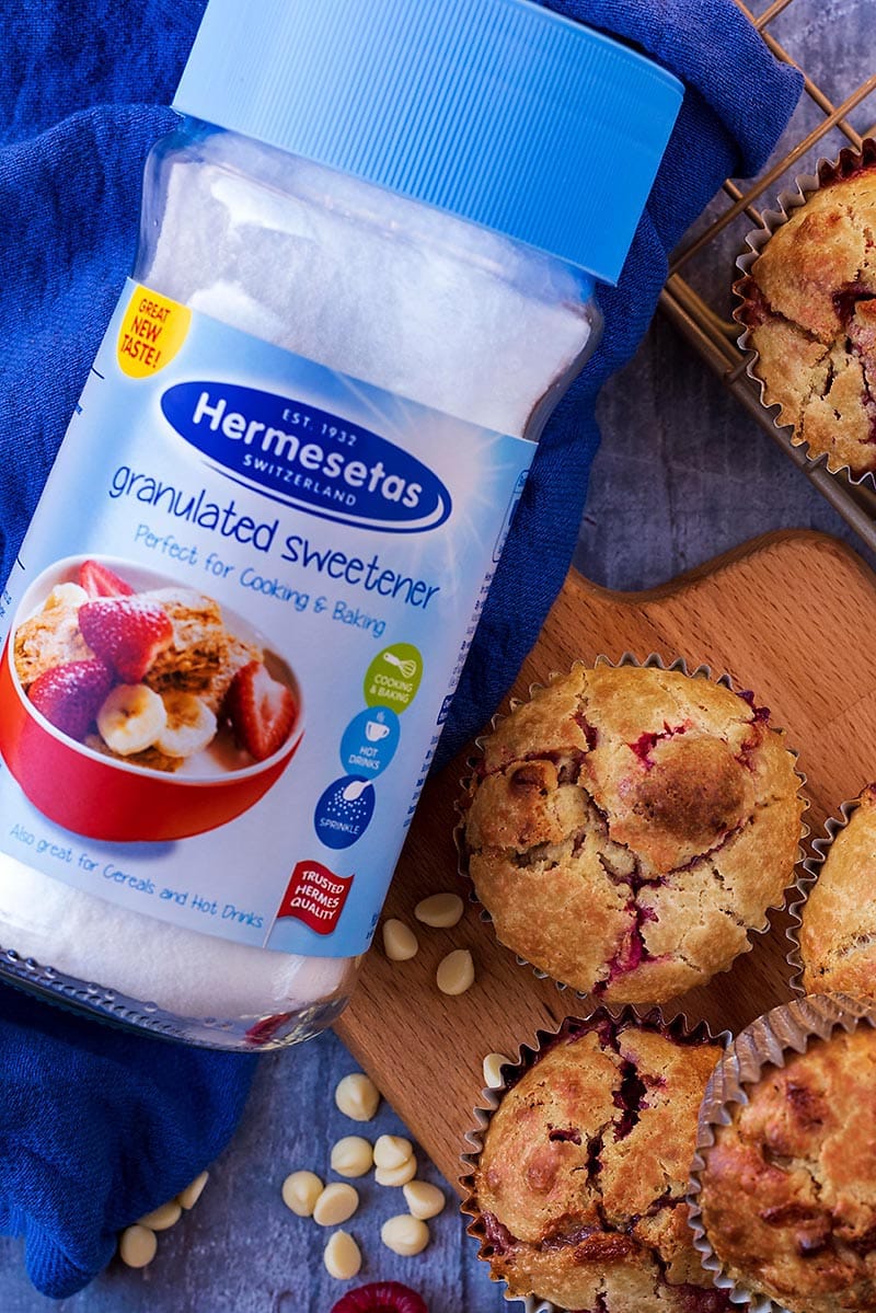 A jar of hermesetas sweetener next to some muffins