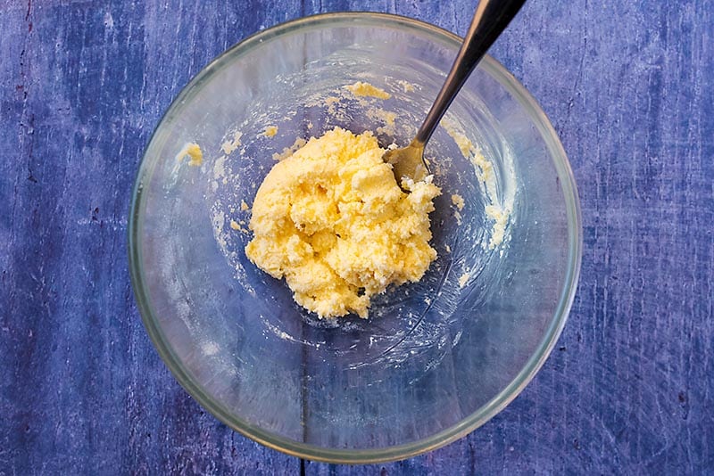 Butter and sugar mixed together in a glass bowl
