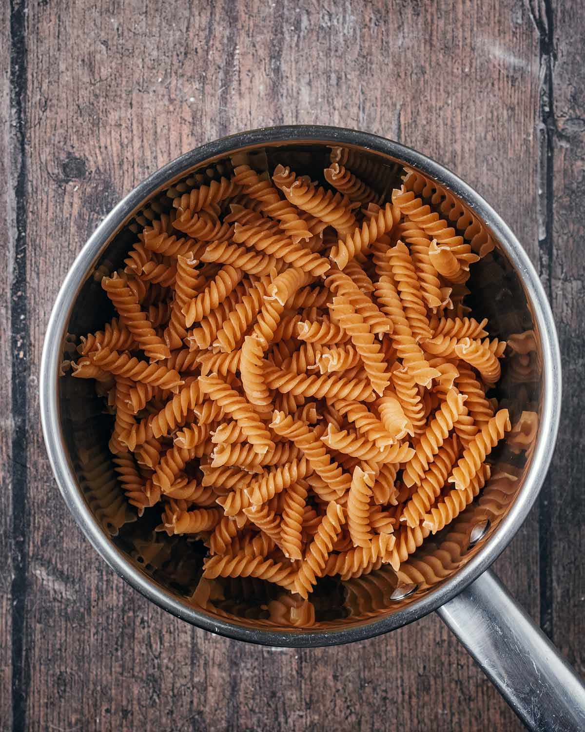 A saucepan containing fusilli pasta.