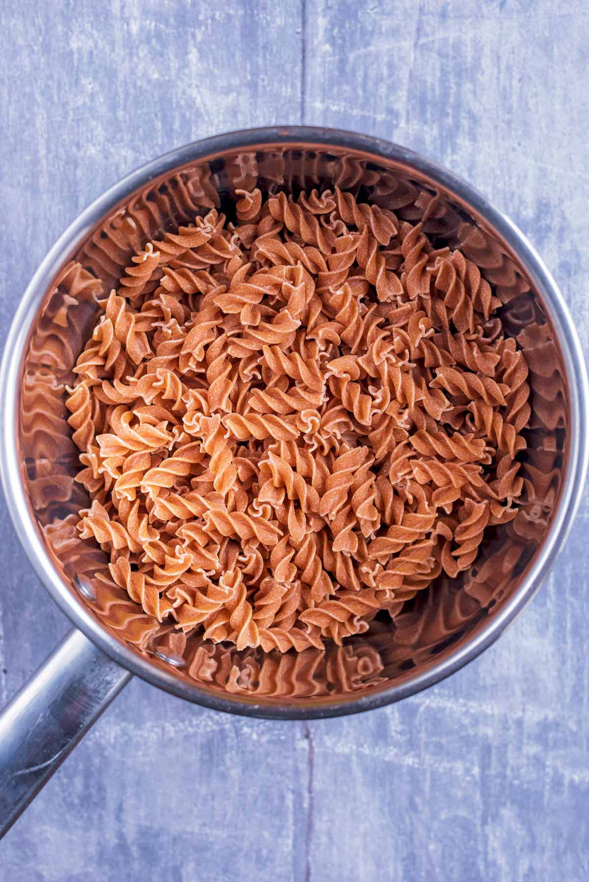 A saucepan containing fusilli pasta.