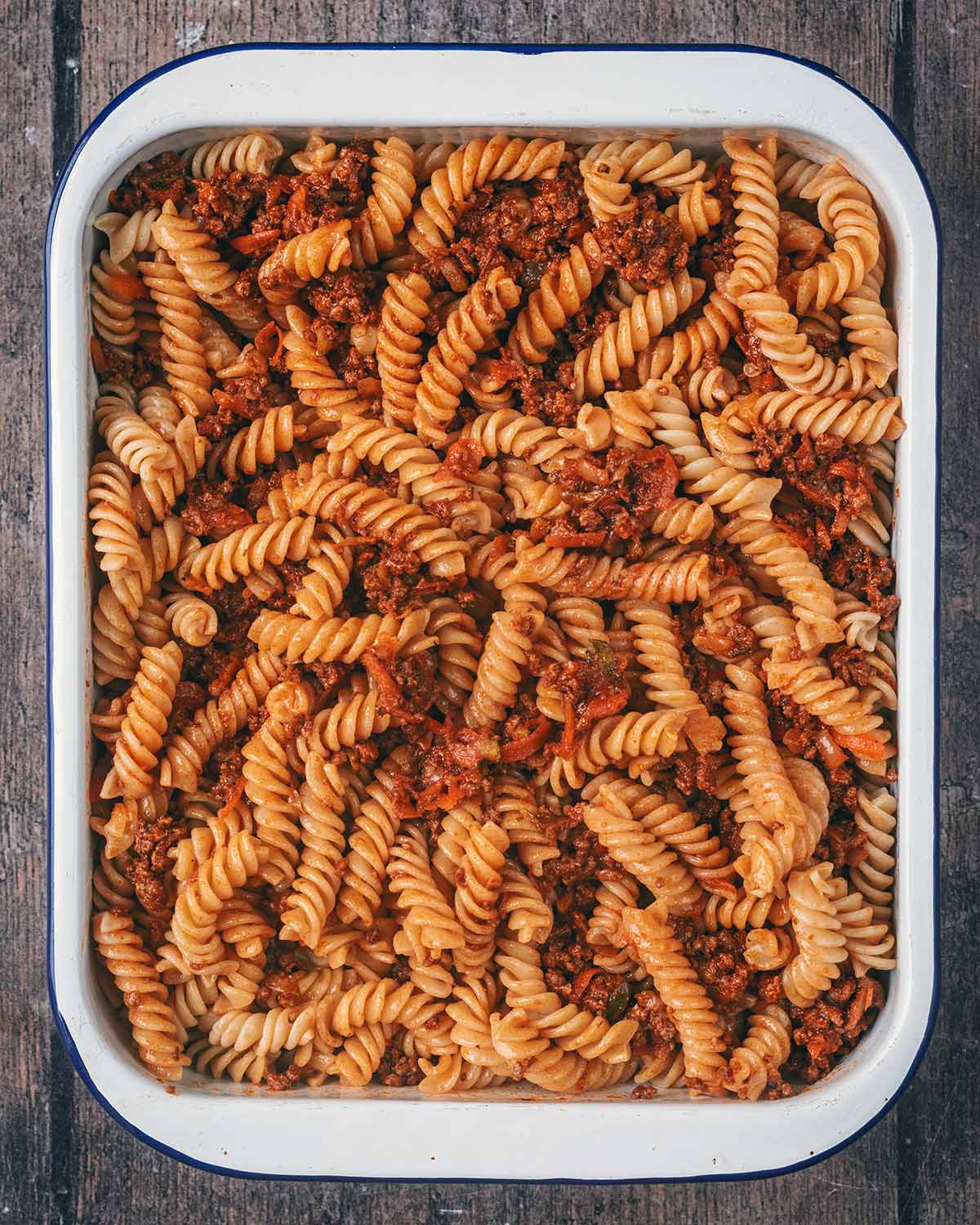 The pasta and bolognese mixed together.