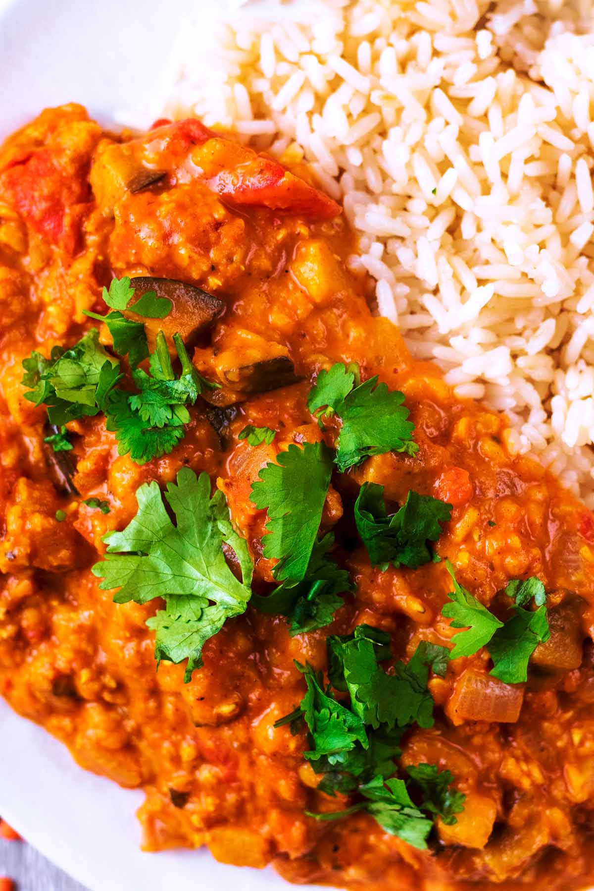 A lentil curry with chopped coriander leaves sprinkled on top of it.