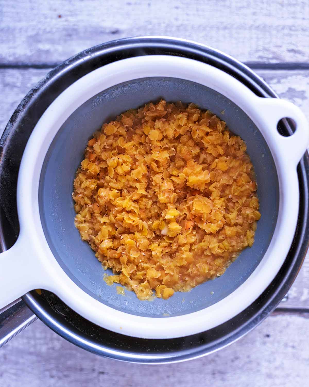 Cooked lentils draining in a colander.
