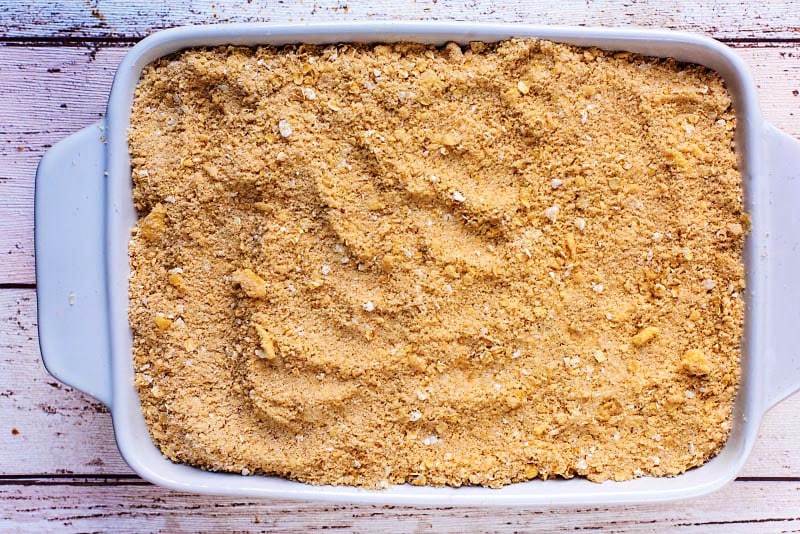 A baking dish containing an uncooked crumble.