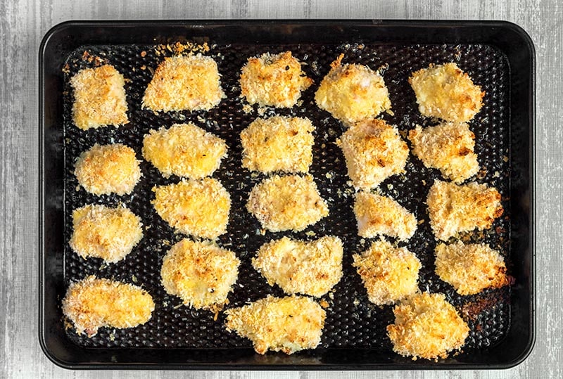 Cooked Parmesan Chicken Bites on a baking tray.