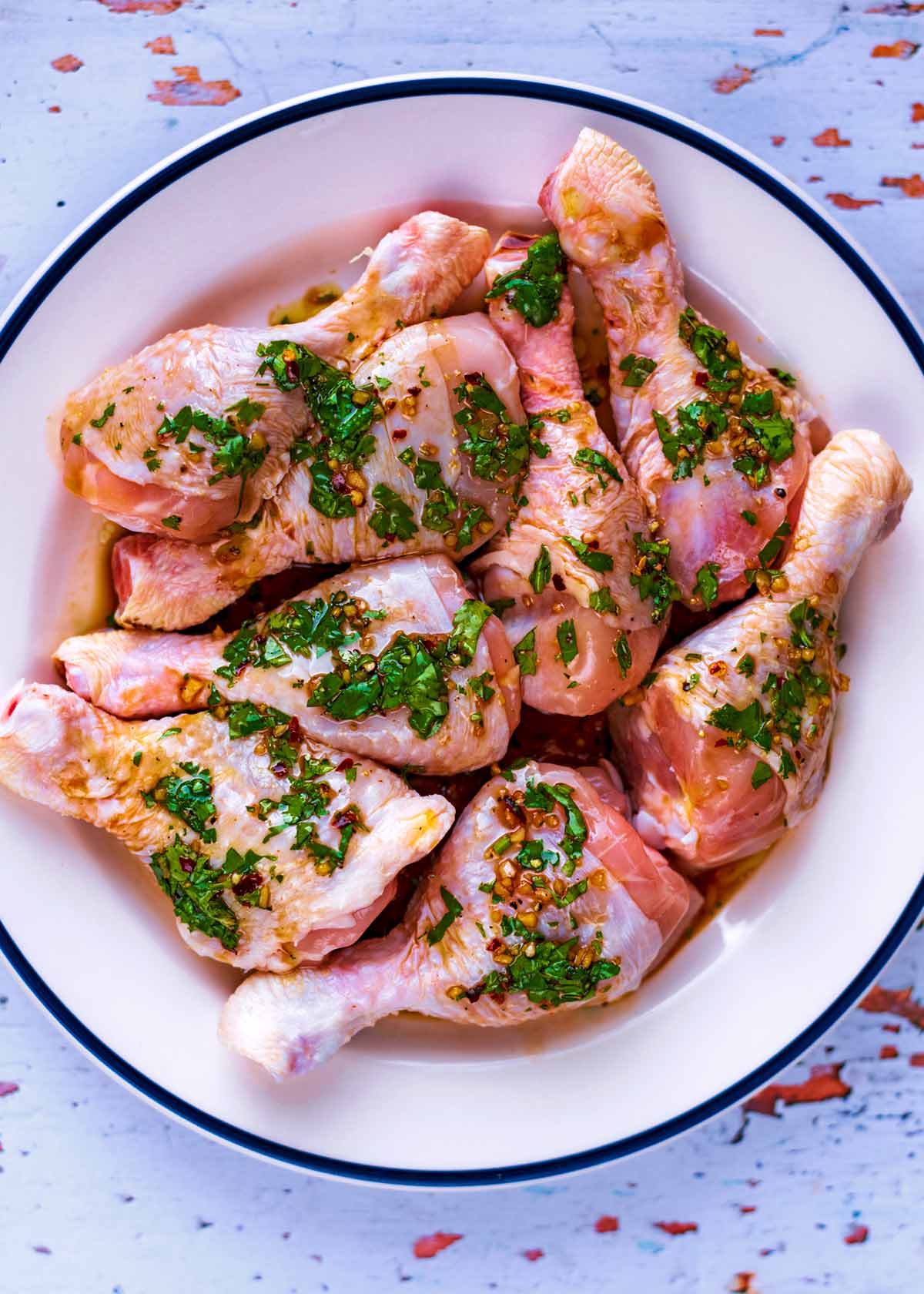 Chicken drumsticks coated in a herb marinade.