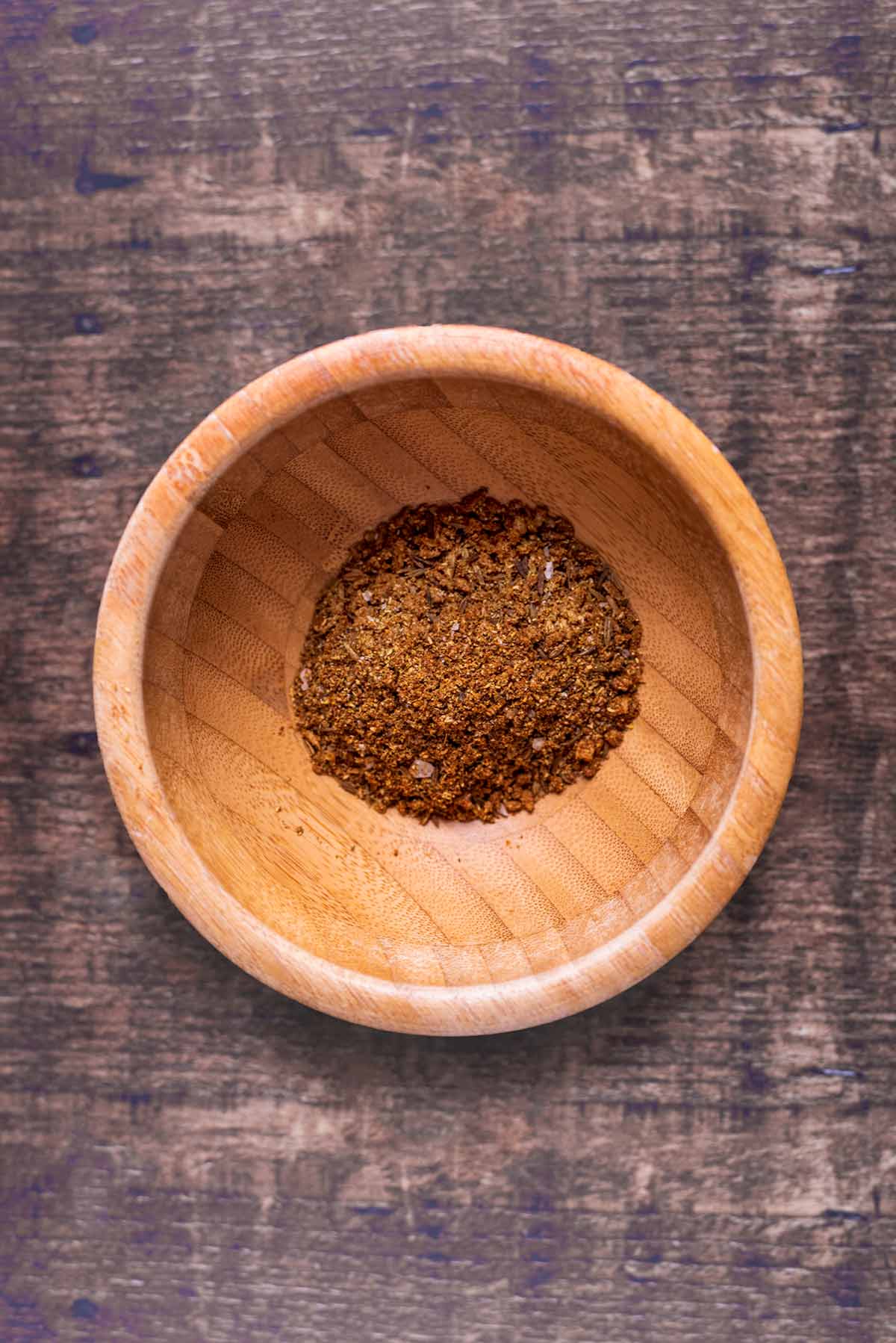 Toasted spices in a small wooden bowl.