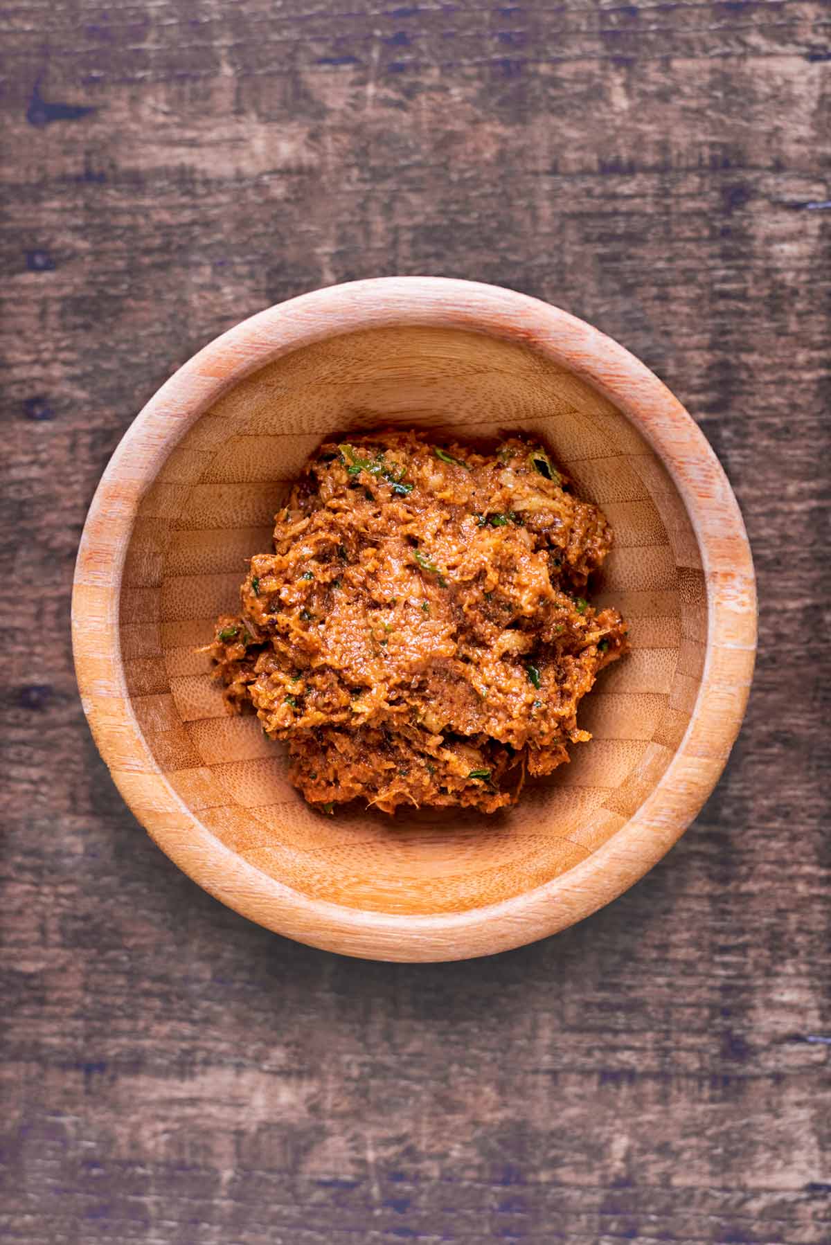 Curry paste in a small wooden bowl.