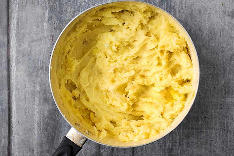 A saucepan full of mashed potato.