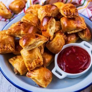 A plate of easy sausage rolls with a small dish of ketchup