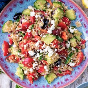 Quinoa Greek Salad on a blue patterned plate.