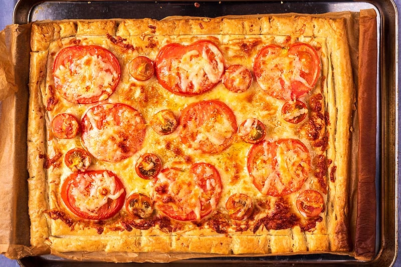 A golden brown tomato tart just out of the oven