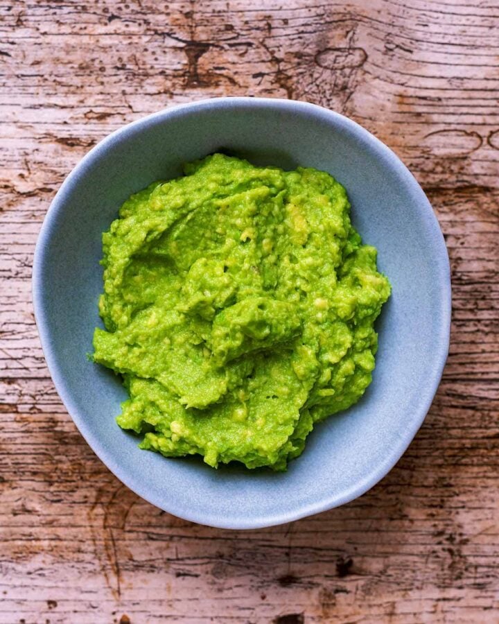 A bowl of mashed avocado.