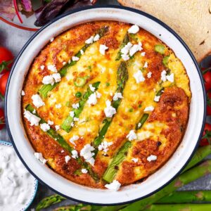 Feta and asparagus frittata in a round baking dish.