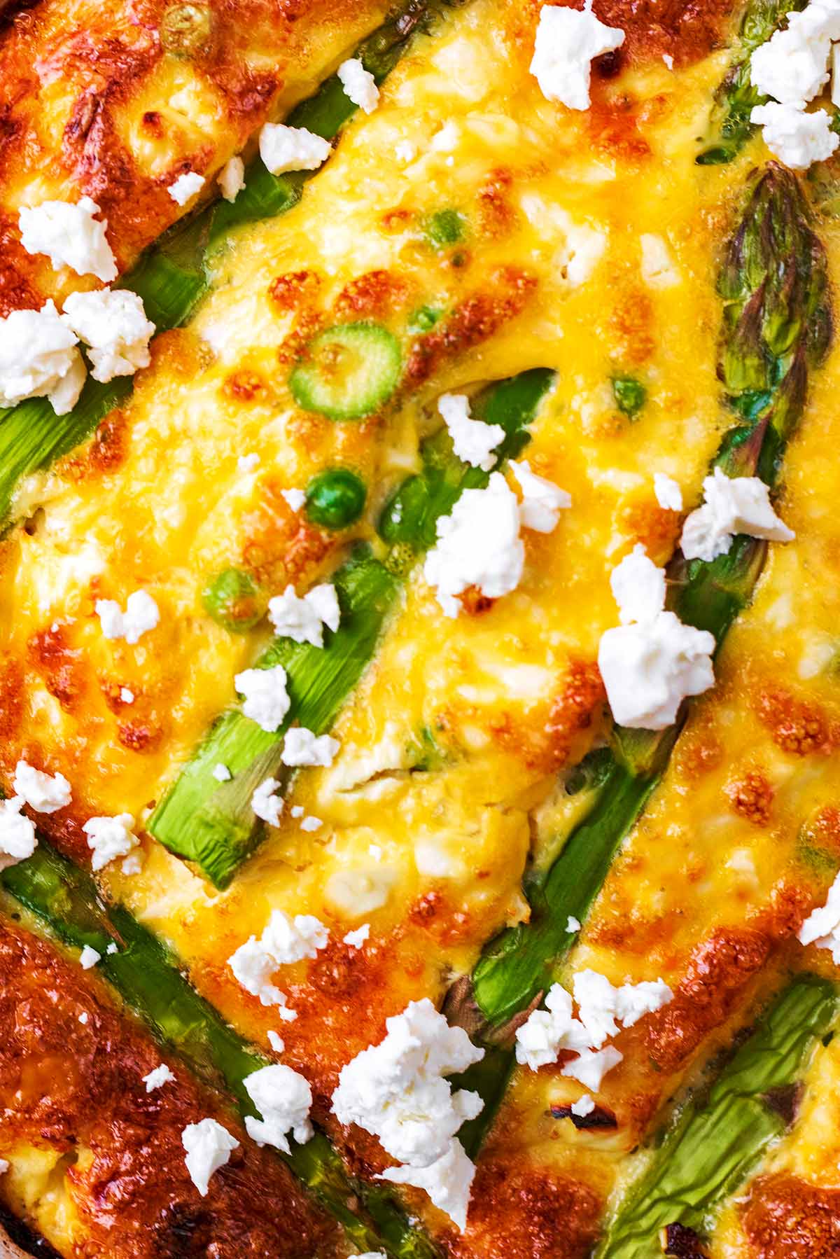 Asparagus spears, peas and feta cheese baked into egg.