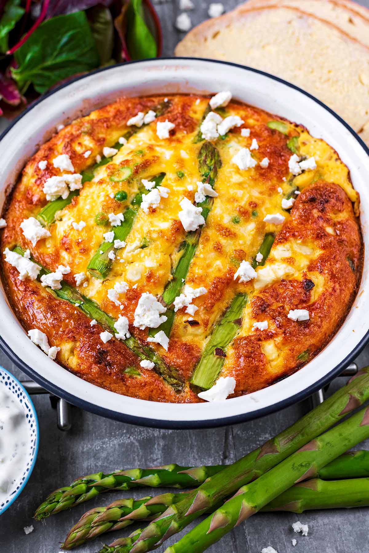 Baked frittata with asparagus and slices of bread.