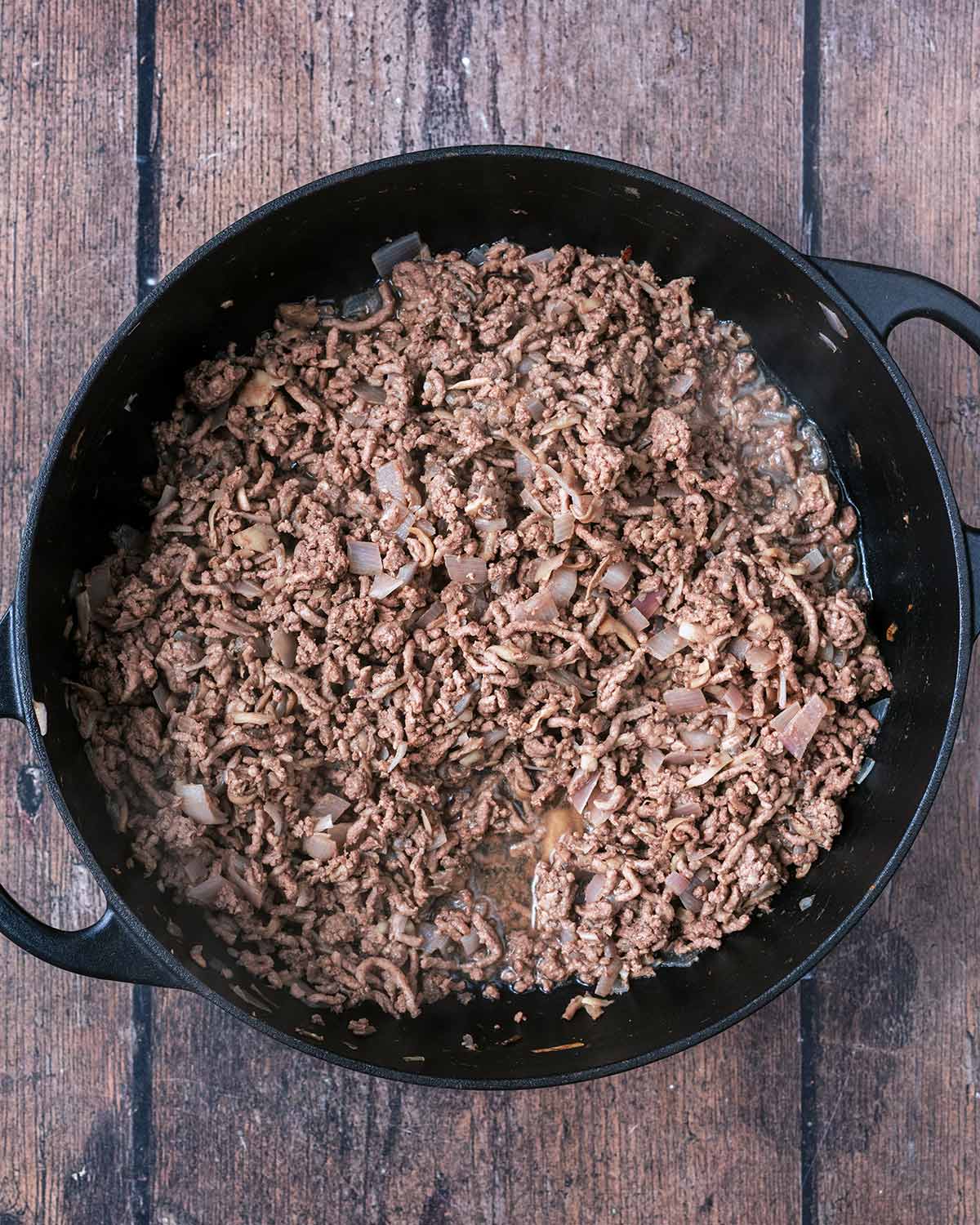 Minced beef added to the pan.