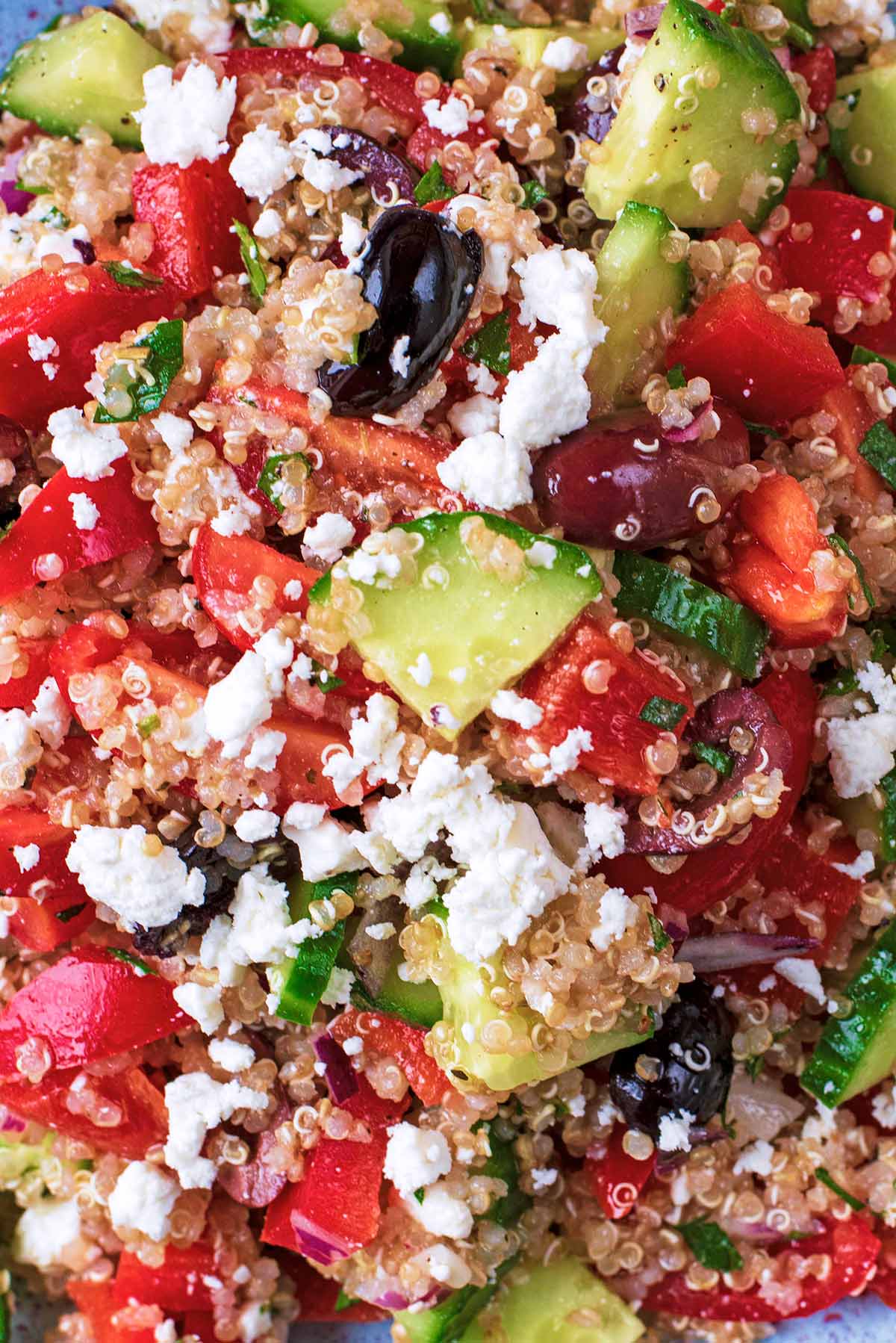 A salad made of quinoa, cucumber, tomato, olives and feta cheese.