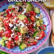 Quinoa Greek salad with a text overlay title.
