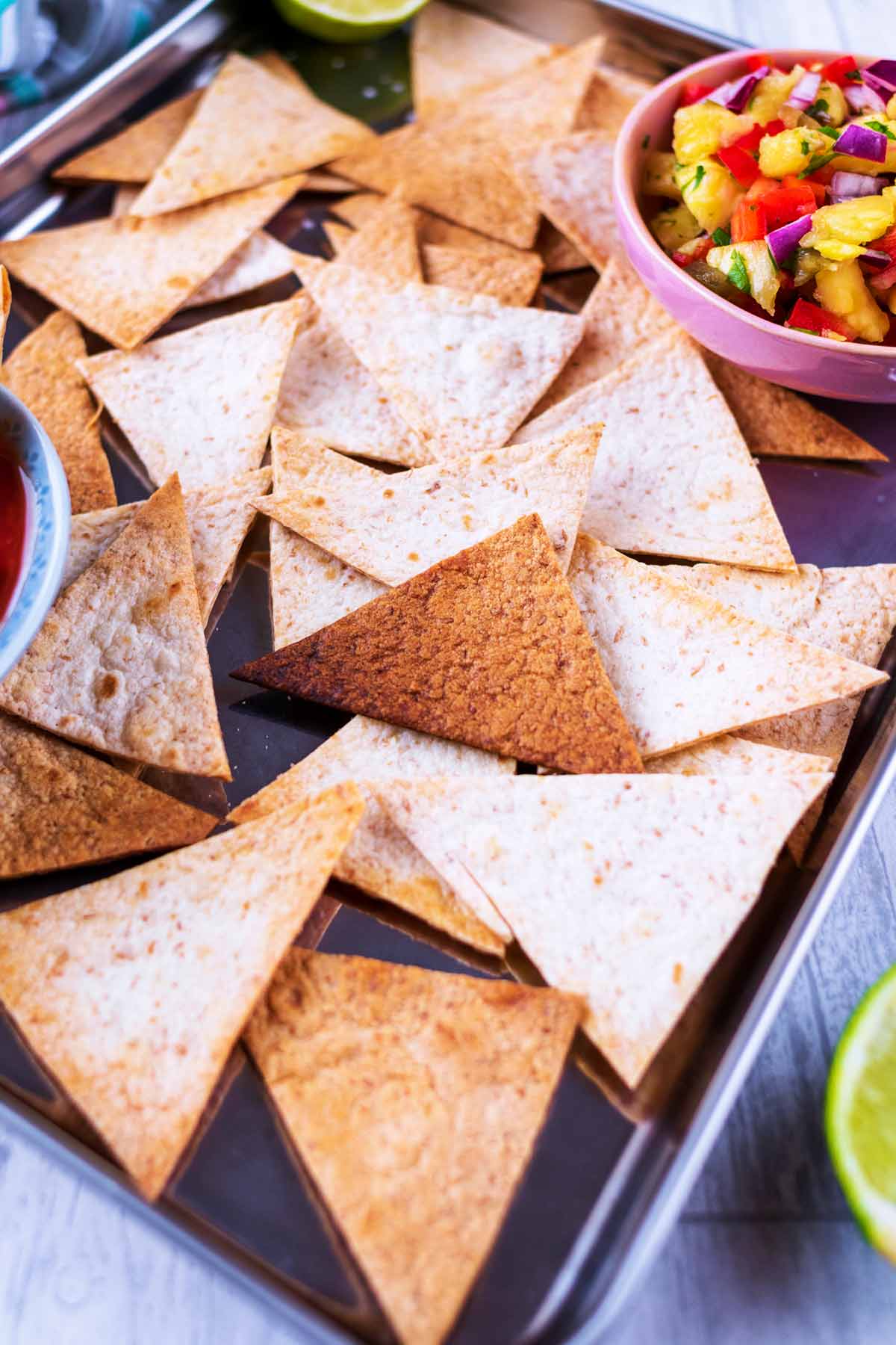 A steel tray covered in tortilla chips.