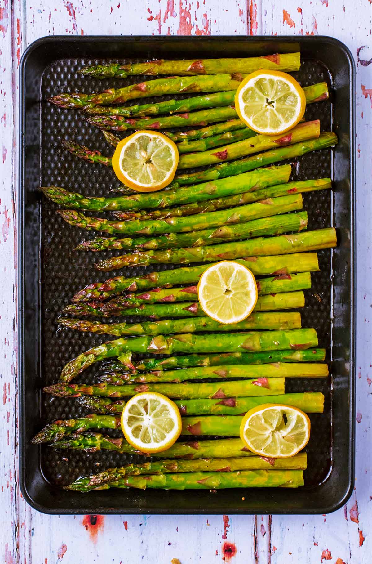 Roasted asparagus on a baking tray.