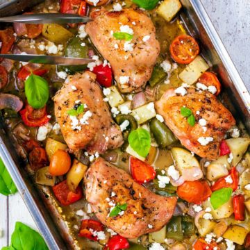 Chicken Tray Bake containing chicken thighs and roasted vegetables.