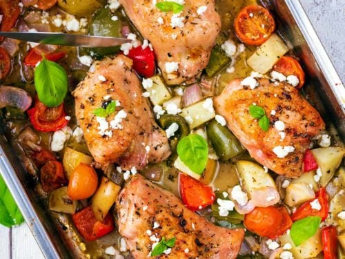 Chicken Tray Bake containing chicken thighs and roasted vegetables.