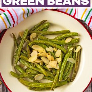 Garlic green beans and flaked almonds on a plate with a title text overlay.