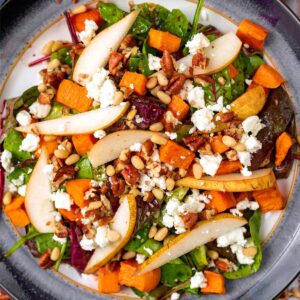 Easy pear salad on a plate next to a blue towel.