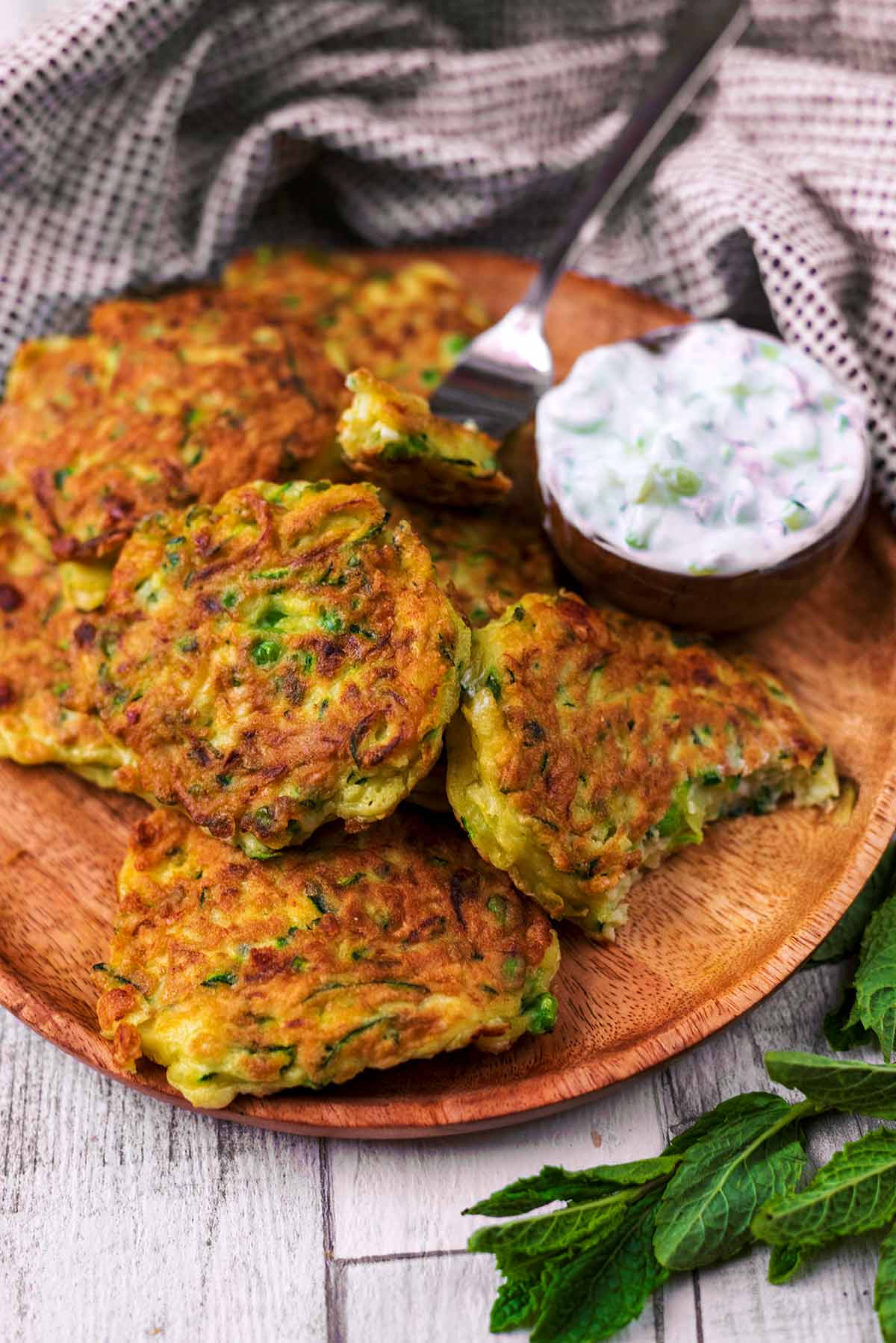 Courgette fritters with a fork cutting a piece off.